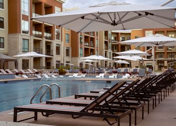 Swimming Pool with loungers surrounding and in the pool at The Residences at Galleria, Overland Park, KS, 66211